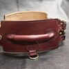 Burgundy English Bridle leather Owned Riding Belt shown from the rear with integrated control handle and solid brass hardware.