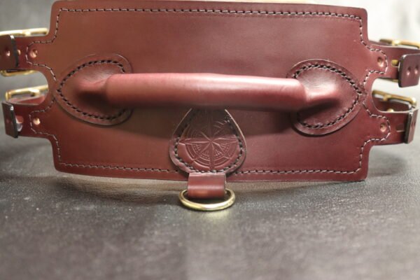 Burgundy English Bridle leather Owned Riding Belt shown from the back to highlight the shaped body, handle, and brass connection points.