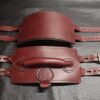 Burgundy English Bridle leather Owned Riding Belt with solid brass hardware, shown front and back while laid flat to highlight its body-shaped curvature and integrated control handle.