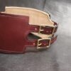 Angled front view of the Burgundy English Bridle leather Owned Riding Belt showing the wide shaped body and brass hardware.