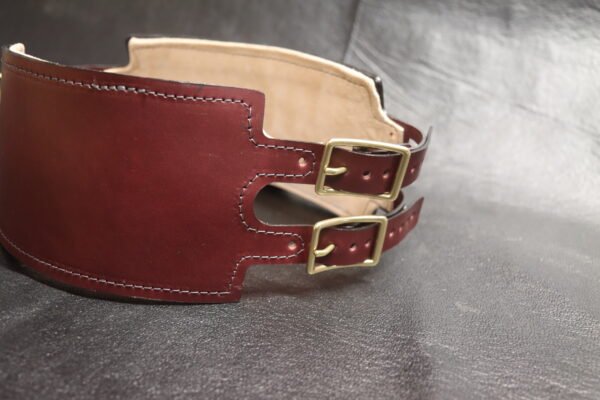 Angled front view of the Burgundy English Bridle leather Owned Riding Belt showing the wide shaped body and brass hardware.