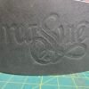 Close-up of the dark green leather Owned Riding Belt “Treasure Belt” showing the embossed word “Treasure.”