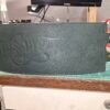 Front view of the dark green leather Owned Riding Belt “Treasure Belt” with “Treasure” embossed across the front panel.
