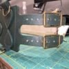 Side detail of the dark green leather Owned Riding Belt “Treasure Belt” showing the dual buckle closure and antiqued brass hardware.