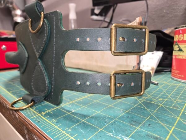 Side detail of the dark green leather Owned Riding Belt “Treasure Belt” showing the dual buckle closure and antiqued brass hardware.
