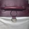 Close-up of the Burgundy English Bridle leather Owned Riding Belt showing the raised control handle, embossed Royal Star sigil, and solid brass D-ring.