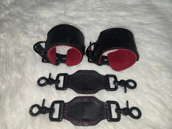 Owned Riding Cuffs 3 Black English Bridle leather Owned Riding Wrist Cuffs with red deersplit lining, shown above two matching leather tethers with black swivel snap hardware.