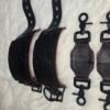 Owned Riding Cuffs 2 Black English Bridle leather Owned Riding Wrist Cuffs with red deersplit lining shown beside matching tethers, highlighting the cuffs’ naturally pre-curved shape and black locking-tongue buckle hardware.