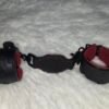 Owned Riding Cuffs - Tethered Black English Bridle leather Owned Riding Wrist Cuffs with red deersplit lining, connected together by a matching leather tether with black swivel snap hardware.