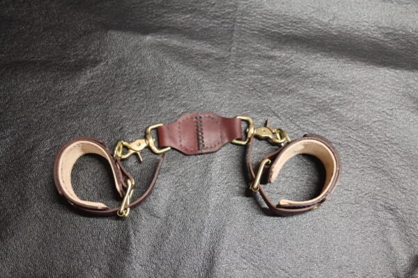 Cuff Set Connected 6 Pair of black leather Owned Wrist Cuffs joined by a matching tether with swivel snap hardware.