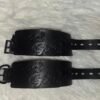 Owned Riding Cuffs - Good Girl Embossed Pair of black English Bridle leather Owned Riding Wrist Cuffs with black locking-tongue buckle hardware, embossed “Good Girl,” and pre-curved construction shaped to fit the wrist.