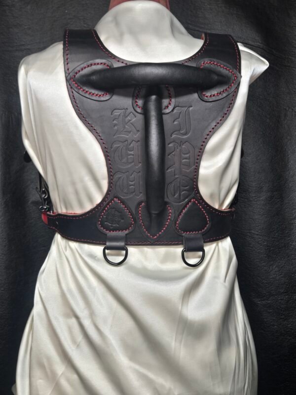 Harness v2.3 - on Mannequin Black - Back Black leather Owned Riding BDSM Harness with red stitching, horizontal and vertical handles, two D-ring attachment points, and custom embossing.