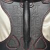 Owned Riding Harness – Black Backpiece Close-Up Black leather Owned Riding BDSM Harness with red stitching, horizontal and vertical handles, two D-ring attachment points, and custom embossing.
