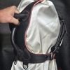 Harness v2.3 - on Mannequin Black - Hand on 1 Black Owned Riding Harness on a mannequin with a hand gripping the integrated rear control handle.