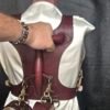 Harness v2.3 - on Mannequin Burgundy - Hand on 2 Burgundy English Bridle leather Owned Riding BDSM Harness with solid brass hardware, shown from the rear with a tether routed through the vertical handle opening and cuffs attached below.